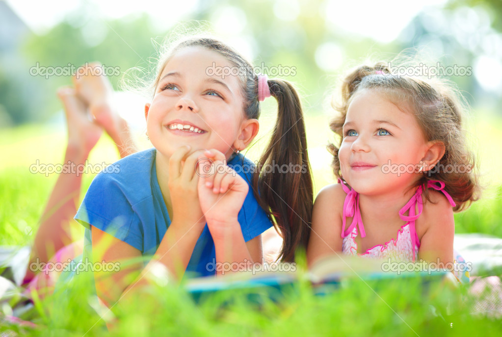Two little girls are reading book Stock Photo by ©Kobyakov 51413845