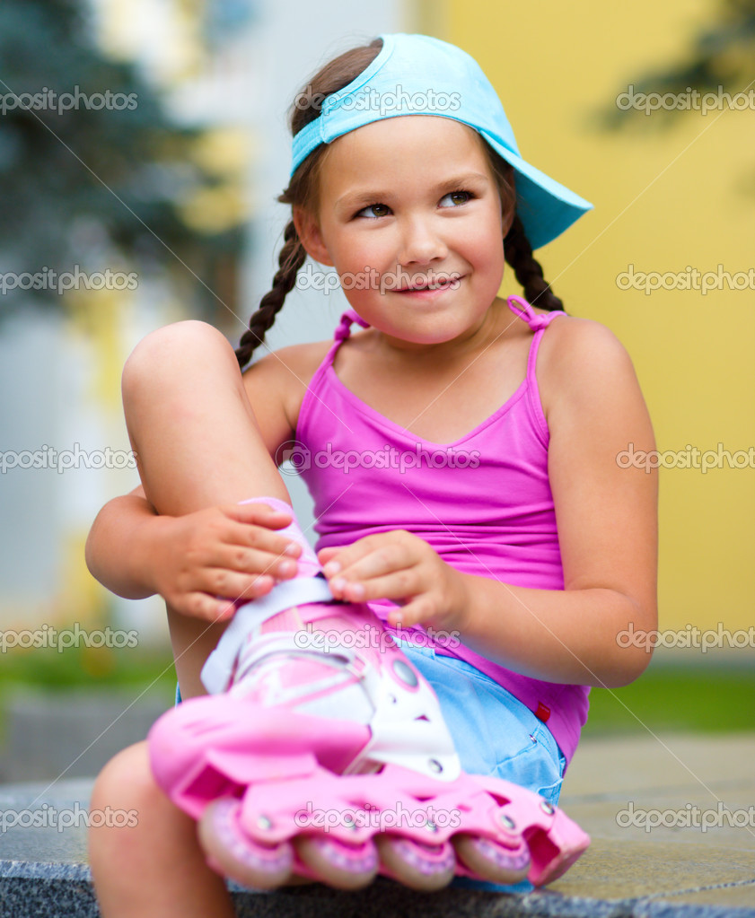 Little girl is wearing rollerblades Stock Photo by ©Kobyakov 51414051