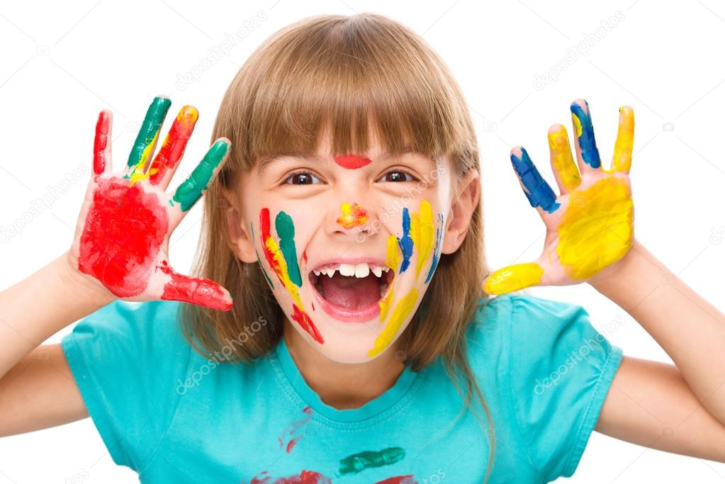 Portrait of a cute girl playing with paints