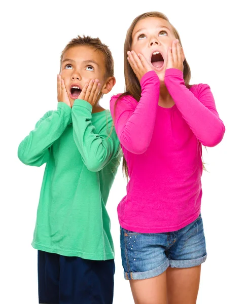 Little girl and boy are holding their faces — Stock Photo, Image