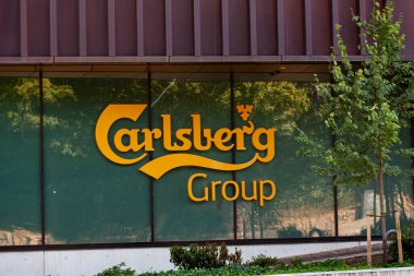 Logotype on head office of Carlsberg Group - one of the leading brewery groups in the world. Copenhagen, Denmark - August 18, 2022.