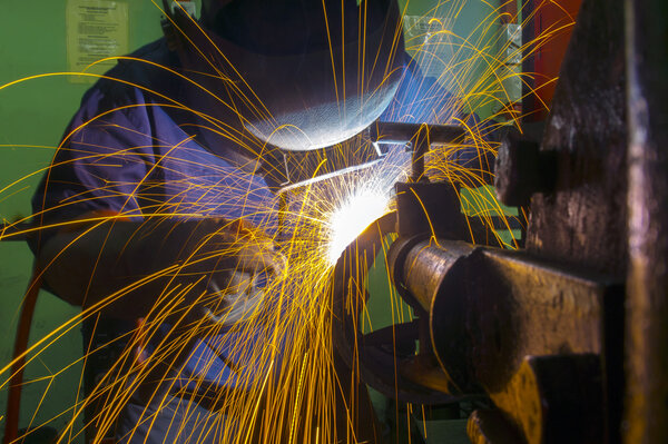 Skilled welder during working at workshop