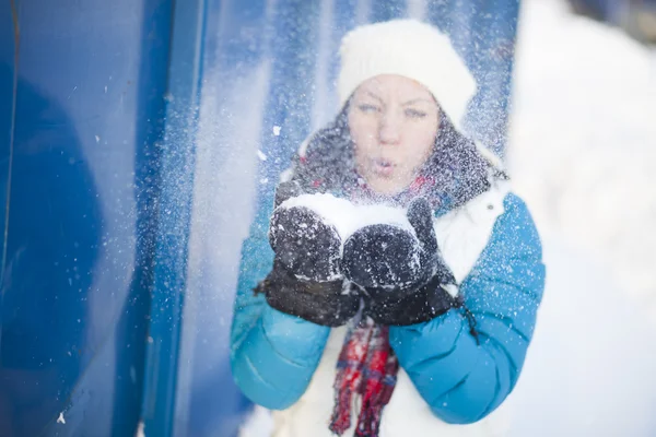 Woman blowing snow — Stock Photo, Image
