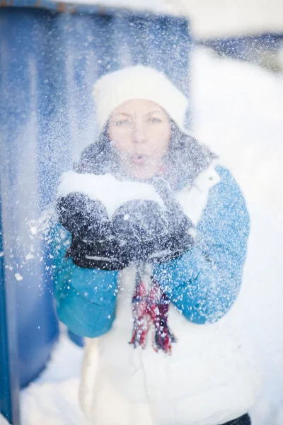 Woman blowing snow — Stock Photo, Image