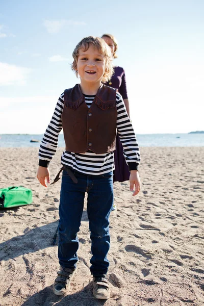 Young boy at beach with mother. — Stock Photo, Image