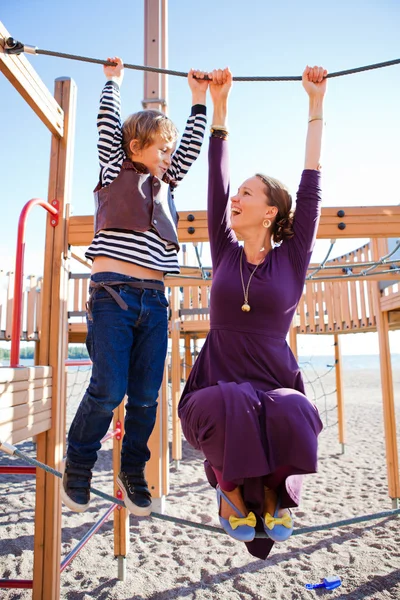 Mother and son playing at playground. — Stock Photo, Image