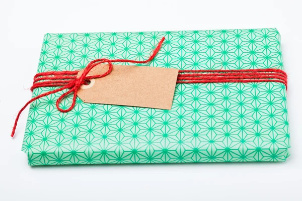 Simple gift with tag — Stock Photo, Image