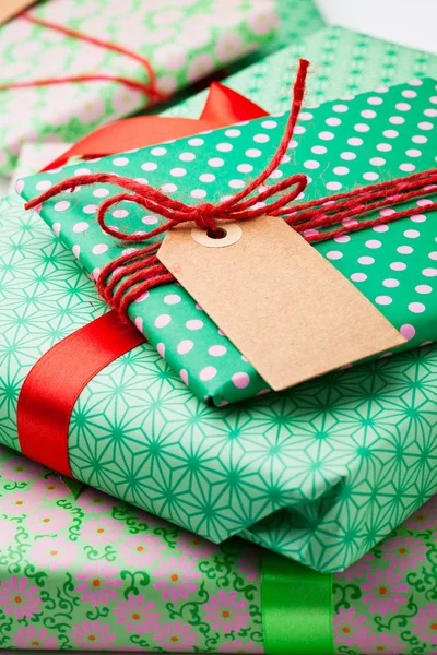 Wrapped gifts with tag — Stock Photo, Image
