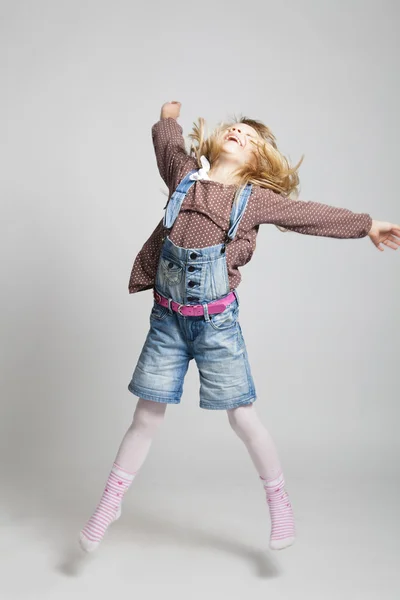 Happy young girl jumping — Stock Photo, Image