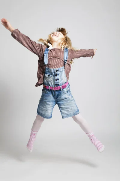 Happy young girl jumping — Stock Photo, Image