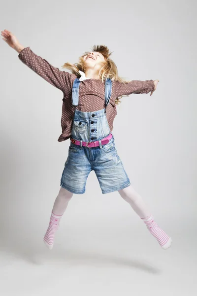 Happy young girl jumping Stock Picture