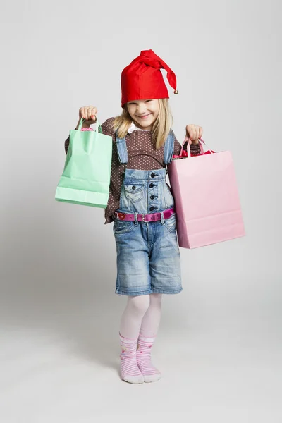 Joyeux jeune fille portant des sacs de Noël — Photo