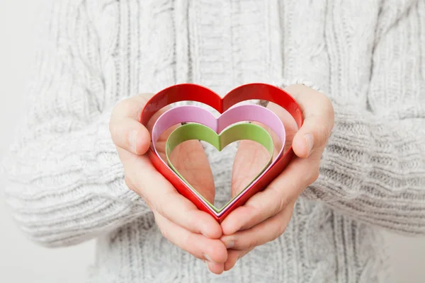 Heart symbols held in hands — Stock Photo, Image