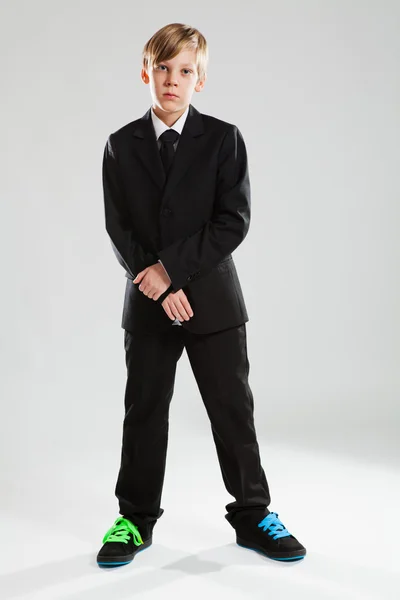 Young boy in black suit and colorful shoes — Stock Photo, Image