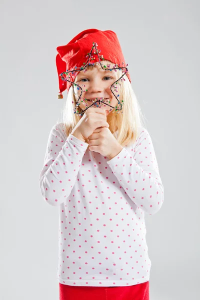 Happy young girl holding Christmas star decoration — Stock Photo, Image