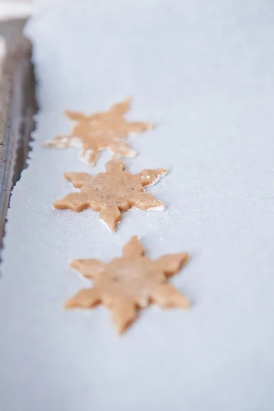 Three shaped gingerbread dough pieces — Stock Photo, Image