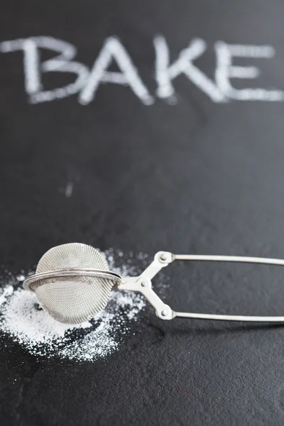 Sieve and icing sugar — Stock Photo, Image