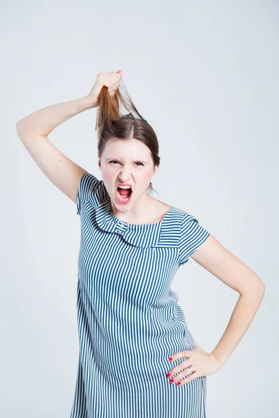 Attractive woman pulling her hair — Stock Photo, Image