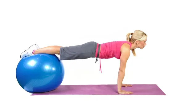 Fit young female pilates instructor showing different exercises — Stock Photo, Image