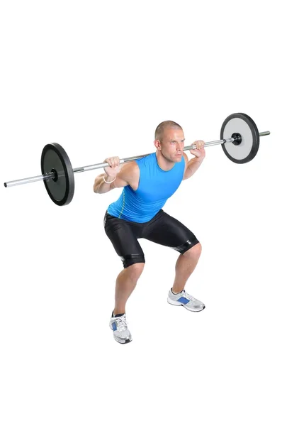 Hombre atleta muscular haciendo ejercicio sobre un fondo blanco — Foto de Stock