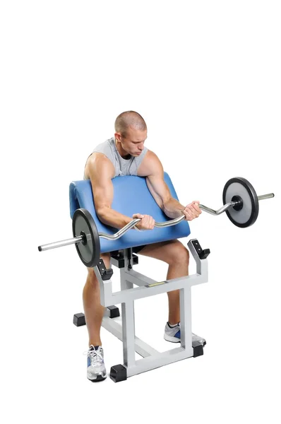 Homem atleta muscular se exercitando em um fundo branco — Fotografia de Stock
