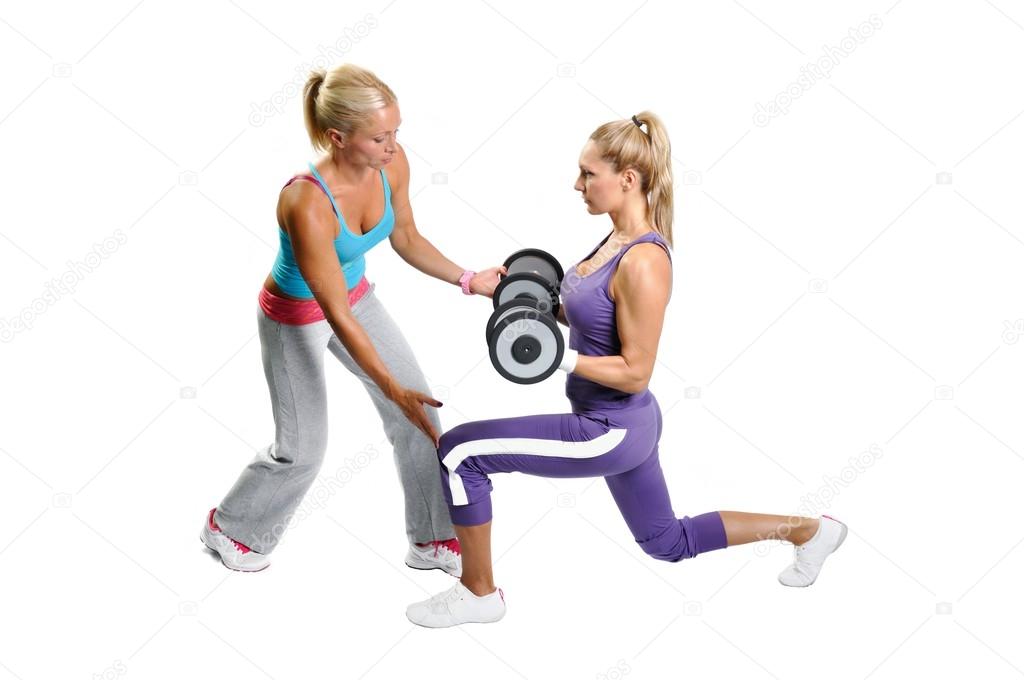Athlete woman exercising with personal fitness trainer on a whit