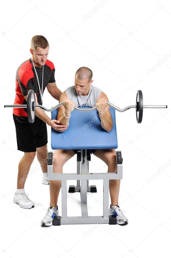 Athlete men exercising with personal fitness trainer on a white