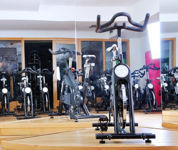 Group of spinning bicycles at fitness studio — Stock Photo, Image