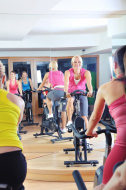 güzel kadınlar bir spinning dersi spor salonunda egzersiz yapıyor