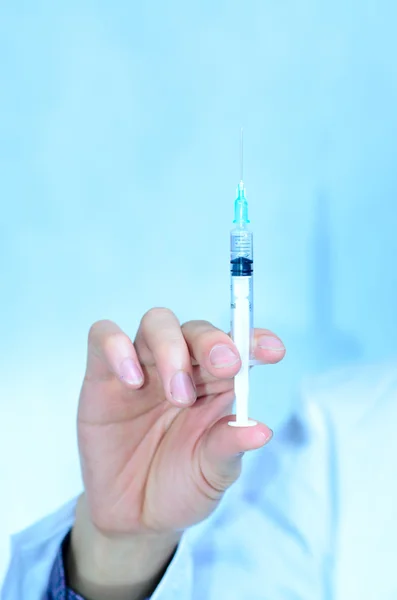 Doctor with medical syringe in hand Stock Photo