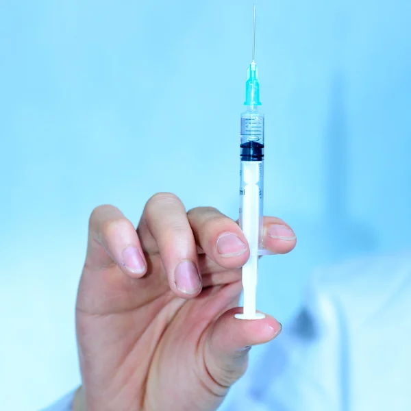 Doctor with medical syringe in hand Royalty Free Stock Images