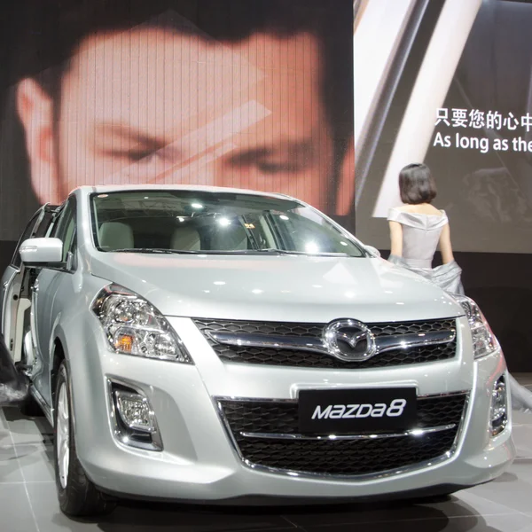 Unidentified model with Mazda 8 car — Stock Photo, Image