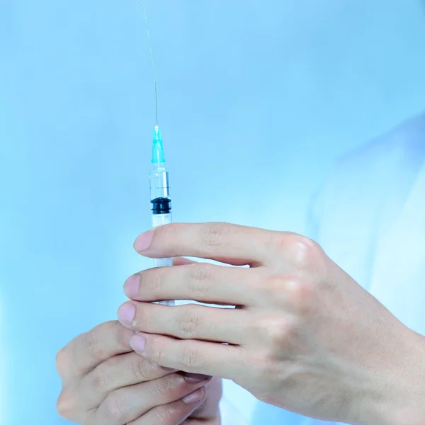 Doctor with medical syringe in hand — Stock Photo, Image