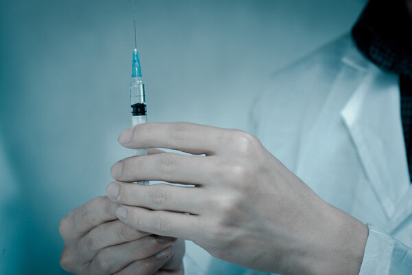 doctor with medical syringe in hand