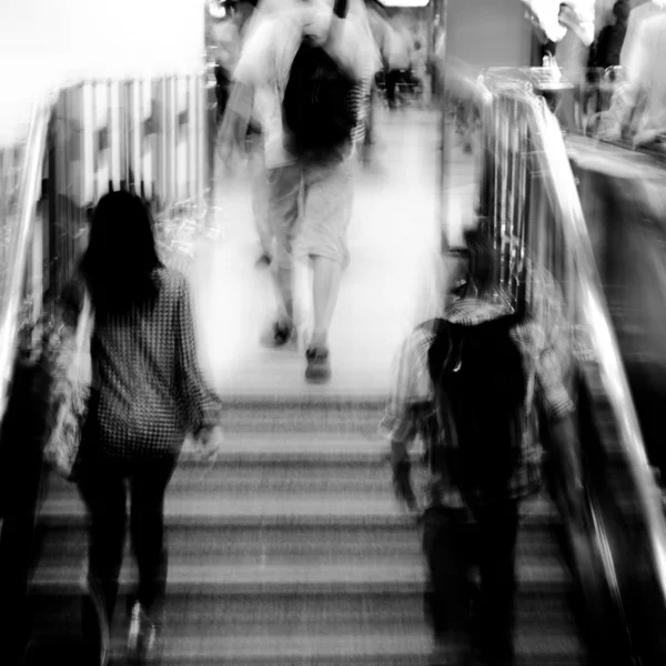 Business on escalator abstract blur — Stock Photo, Image