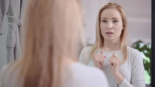 Saddened female with pregnancy test — Stok video