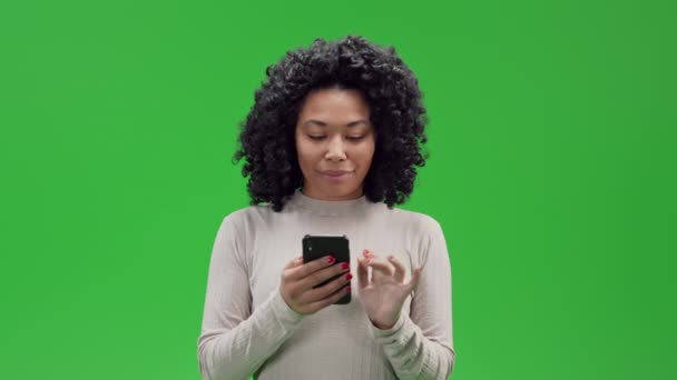 African American Woman Using Smartphone Scrolling Playing Chatting Laughing Looking — Stok Video