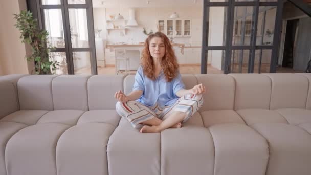 Woman Practicing Meditation Sitting Couch Living Room Practice Reduce Stress — Stockvideo