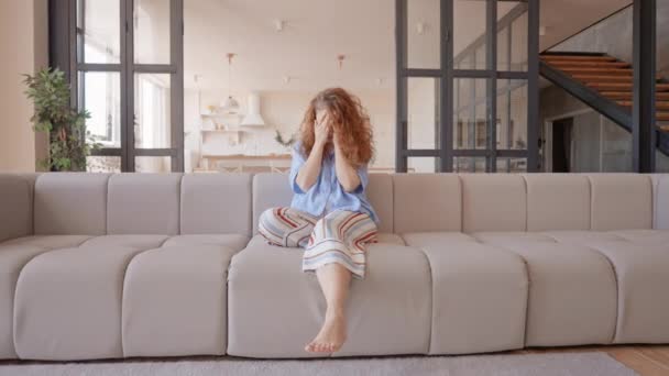 Woman Long Curly Hair Hide Face Hands Sitting Sofa Looking — Stockvideo
