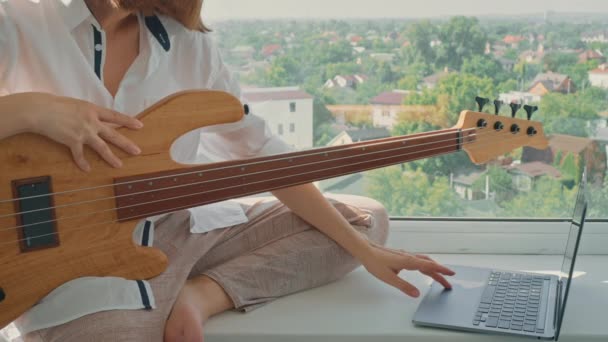Woman Sitting Windowsill Learning Play Guitar Watching Online Tutorial Musician — Videoclip de stoc