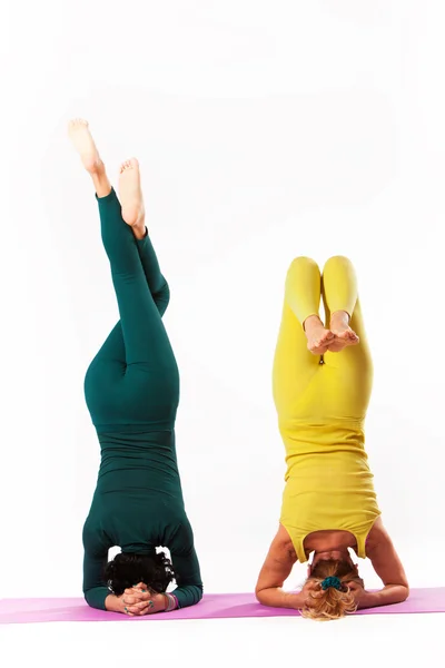 Senior and younger woman practice yoga — Stock Photo, Image