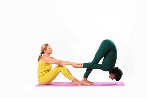 Senior and younger woman practice yoga — Stock Photo, Image