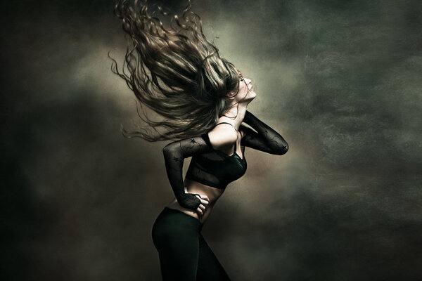 Attractive young woman dancing long hair fly , studio shot