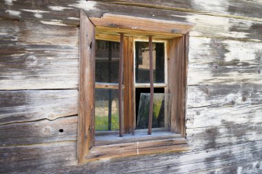 Wooden farmhouse in Bavaria with many details from the roof to wooden windows and doors