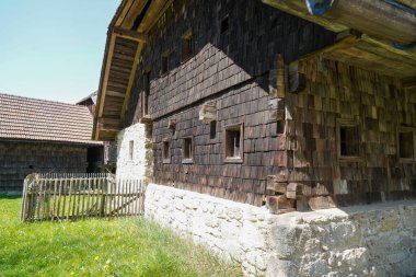Wooden farmhouse in Bavaria with many details from the roof to wooden windows and doors