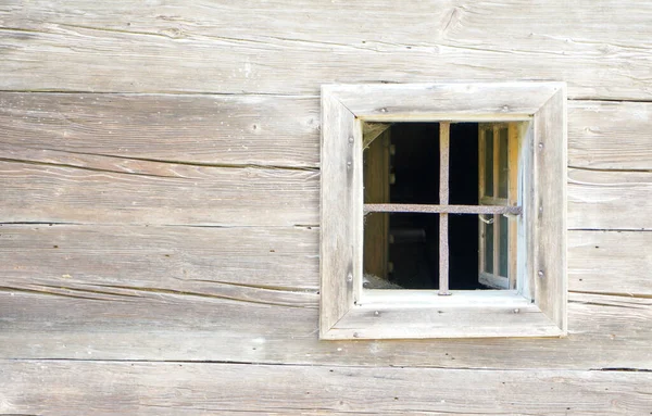 Aged wooden window with glazing and partially weathered in rustic homes