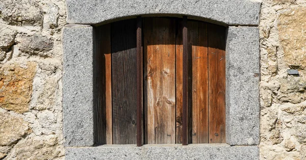 Aged wooden window with glazing and partially weathered in rustic homes