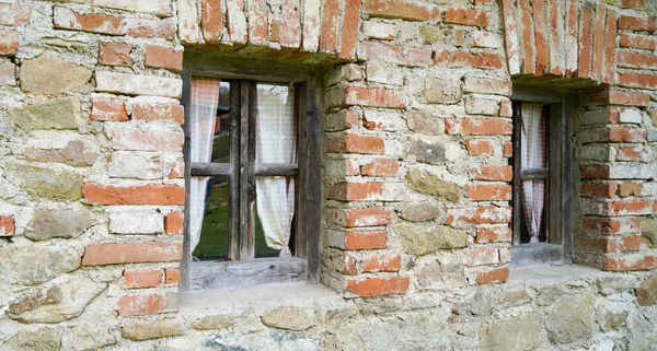 Aged wooden window with glazing and partially weathered in rustic homes