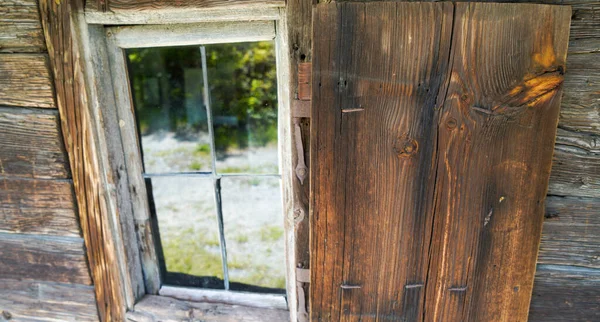 Aged wooden window with glazing and partially weathered in rustic homes