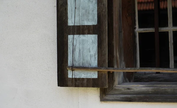 Wooden window with glazing and partially weathered in rustic homes